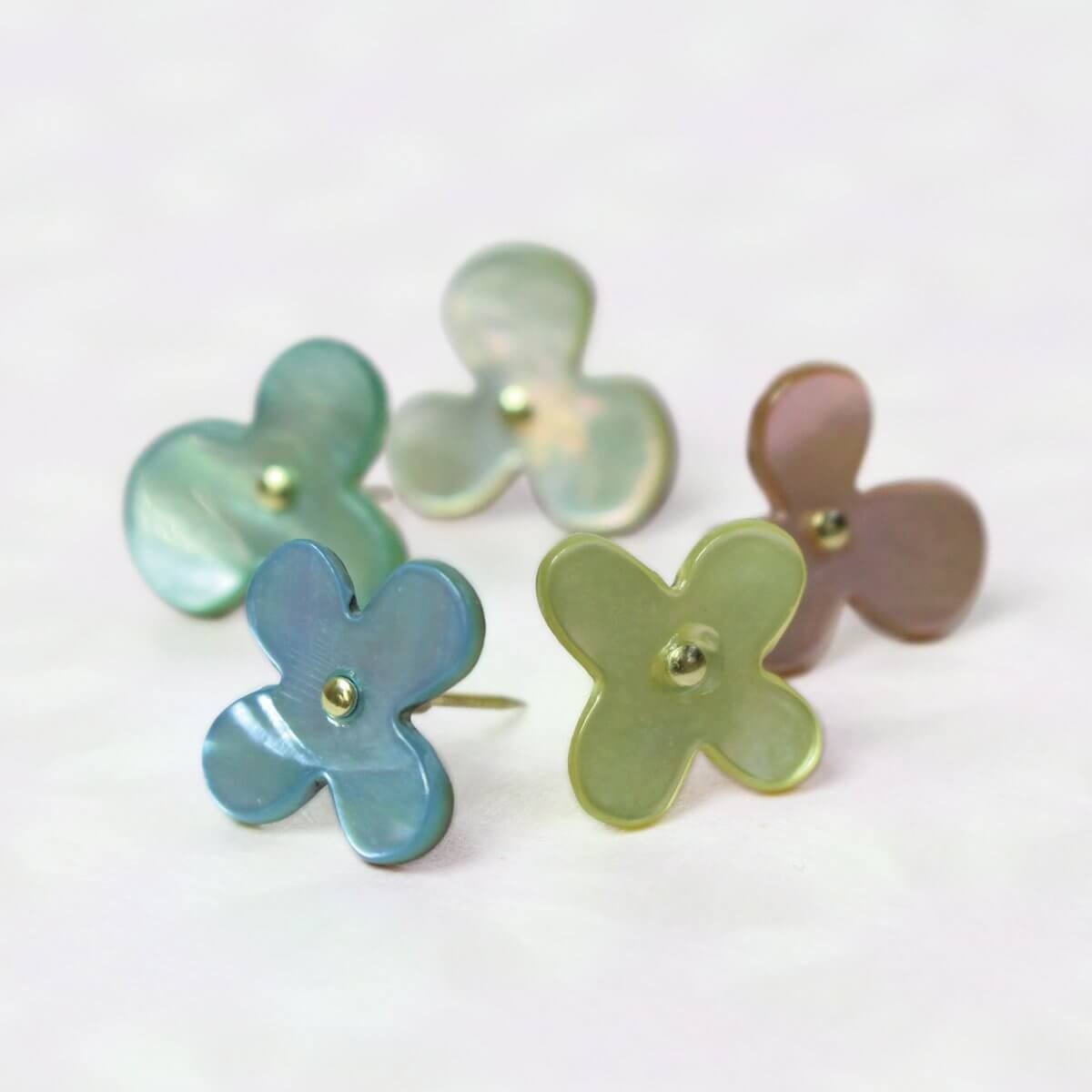 Close up of shell push pins in pastel colours