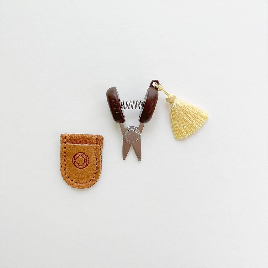 Mini sewing scissors with yellow tassel and leather case