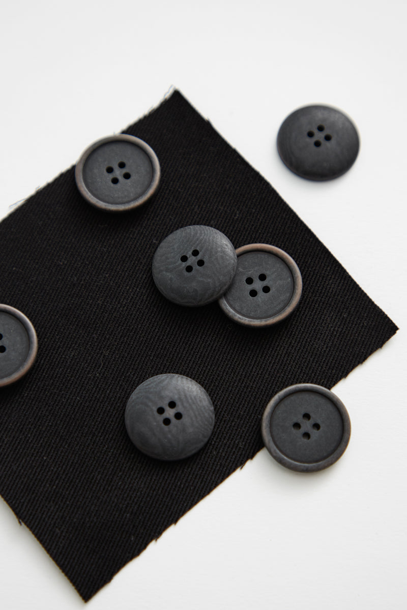Close up of pile of black corozo sewing buttons
