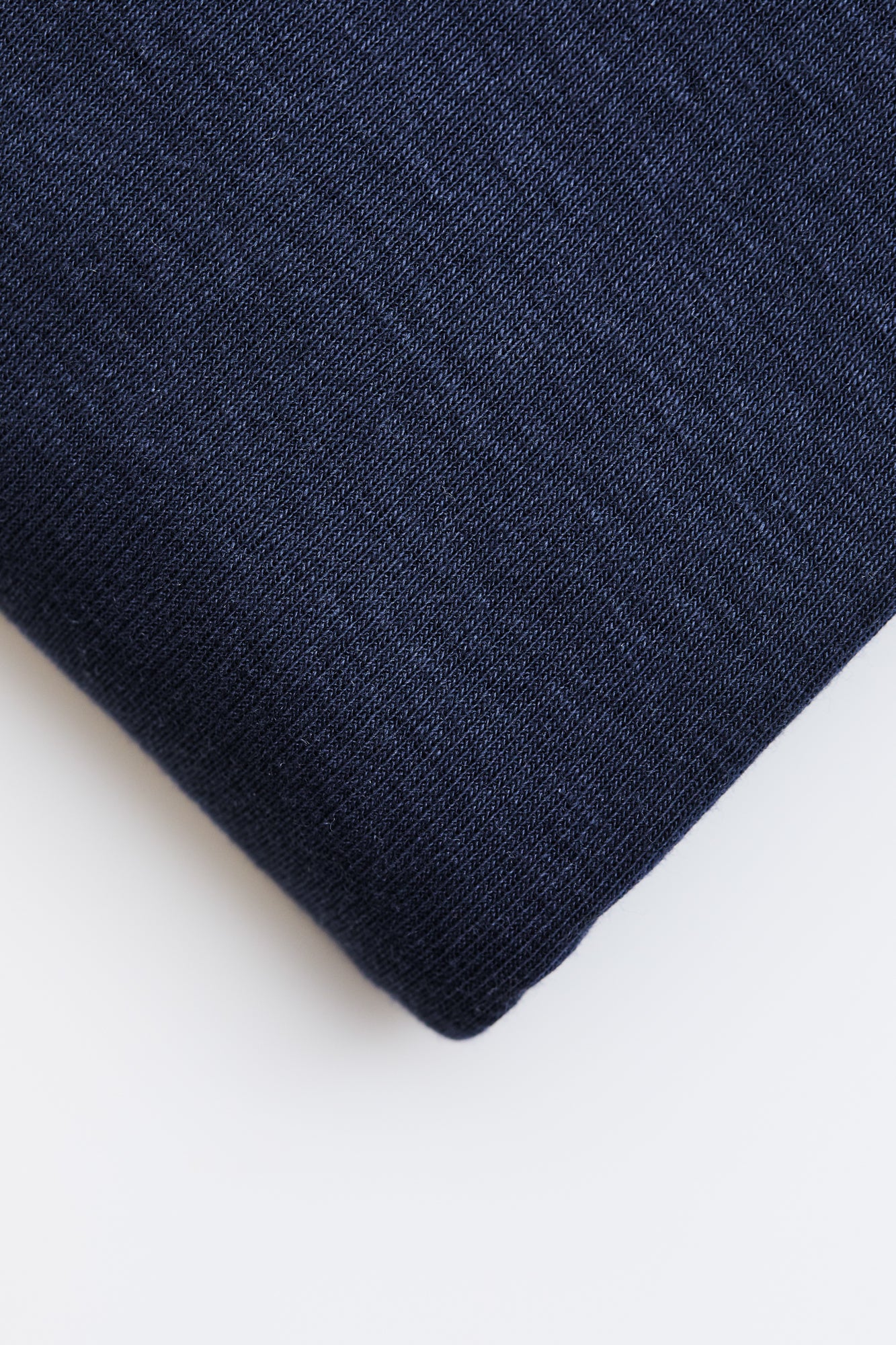 Close up of navy organic cotton and tencel jersey sewing fabric