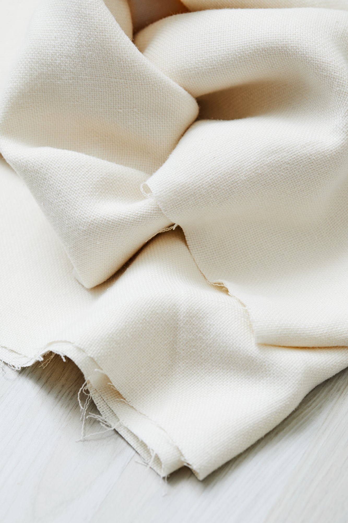Close up of Mara linen blend tencel sewing fabric in shell (cream)