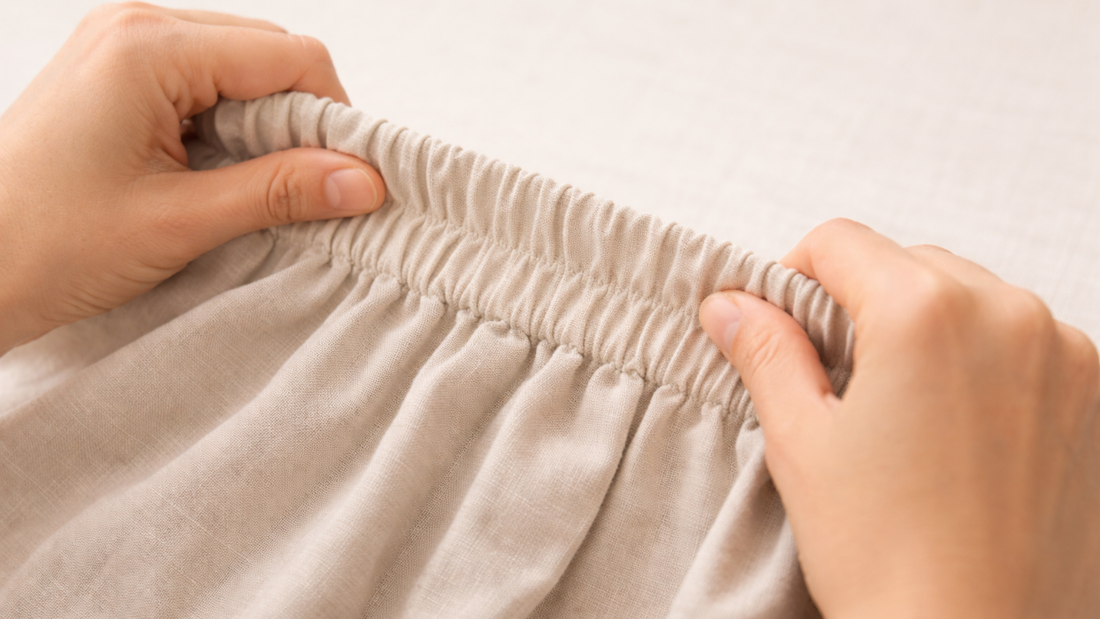 Hands holding the elastic waistband of a pair of trousers