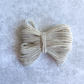 Ecru Shirring elastic bundled into a bow