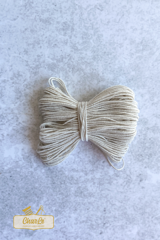 Ecru Shirring elastic bundled into a bow
