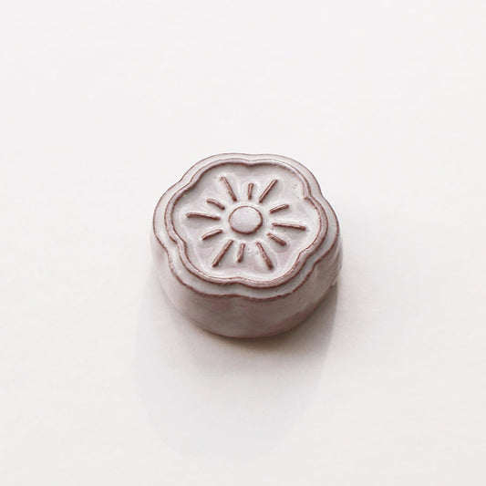 Small white ceramic needle rest by cohana on white background