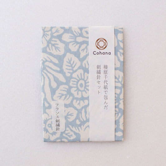 Pack of embroidery needles covered in patterned Japanese washi paper in pale blue and white