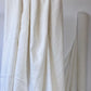 Natural white Organic cotton and hemp woven sewing fabric draped over clothes rail 