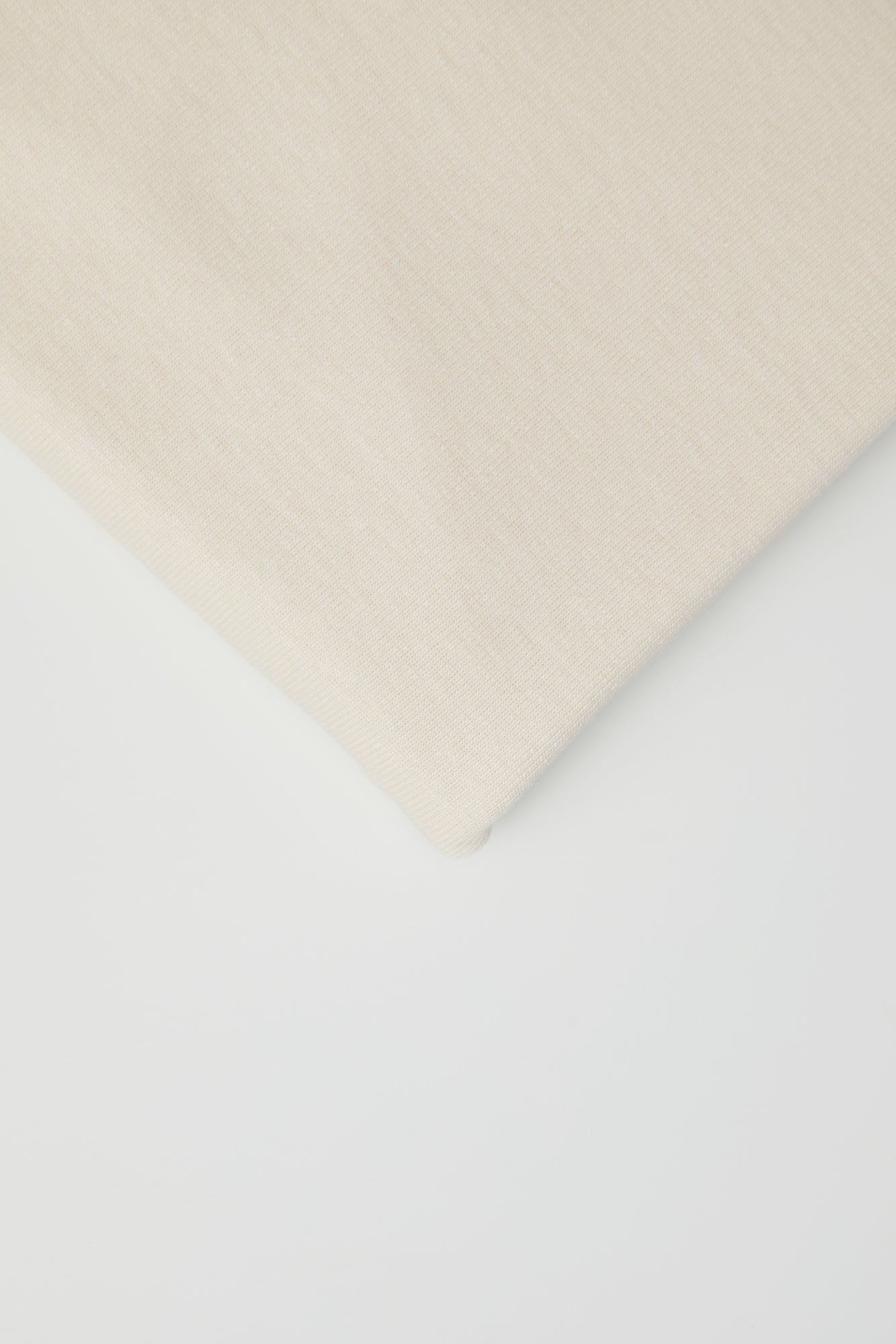 Close up of organic cotton and tencel knit sewing fabric in cream