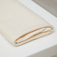 Cream coloured organic cotton and tencel jersey knit sewing fabric folded on top of white table