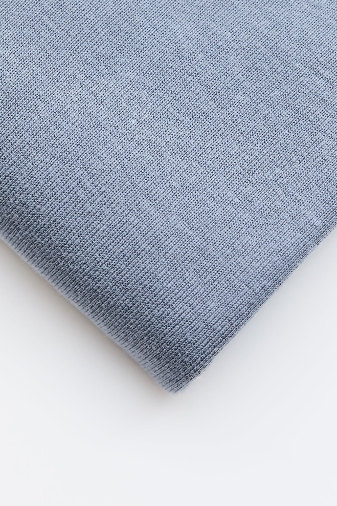 Close up of sky blue organic cotton and tencel knit sewing fabric