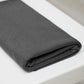 Dark grey organic cotton and tencel jersey knit sewing fabric folded on white table