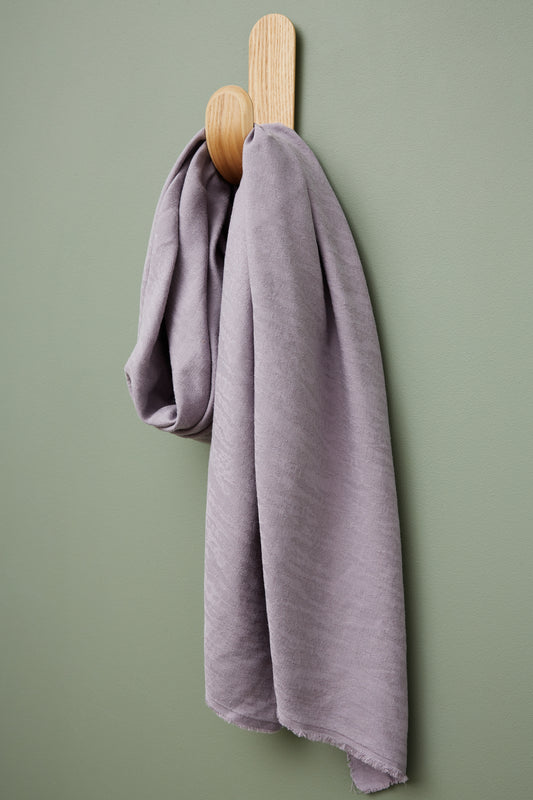 Hoya jacquard linen blend sewing fabric in colour purple haze, hanging on hook