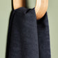Close up of linen and tencel blend sewing fabric hanging on hook in navy