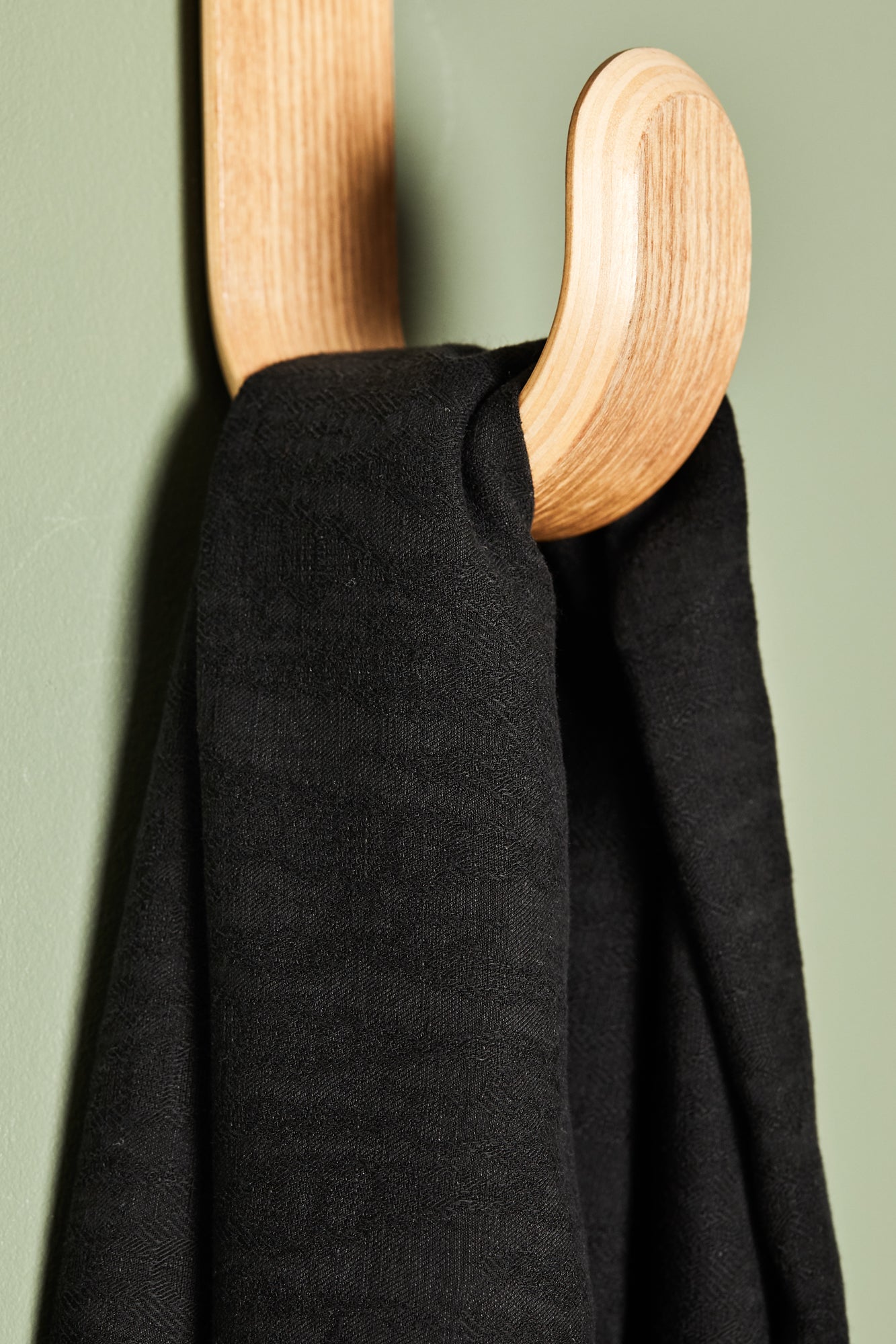 Black linen tencel sewing fabric hanging on hook