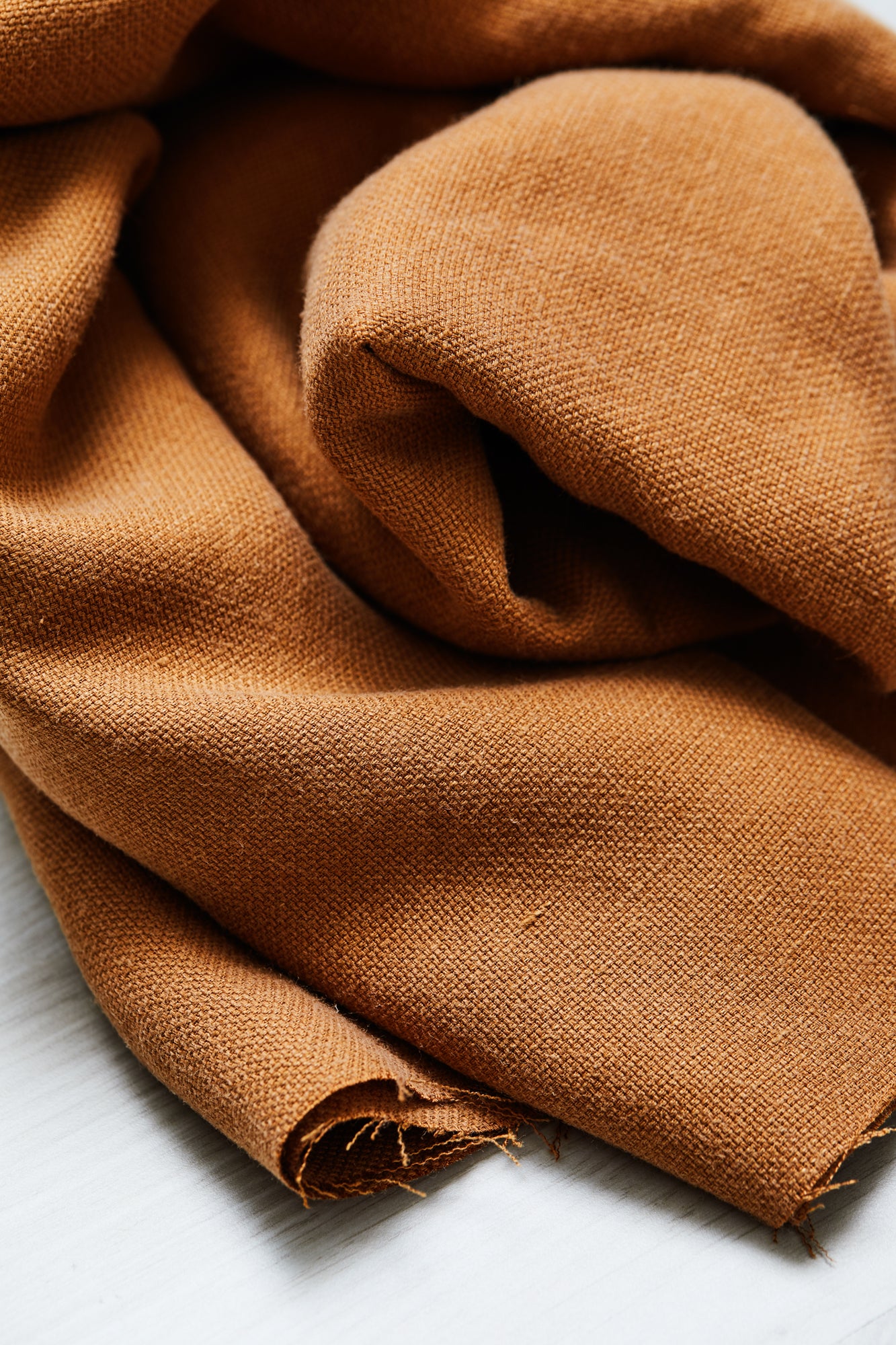 Close up of Mara linen blend tencel sewing fabric in colour mustard