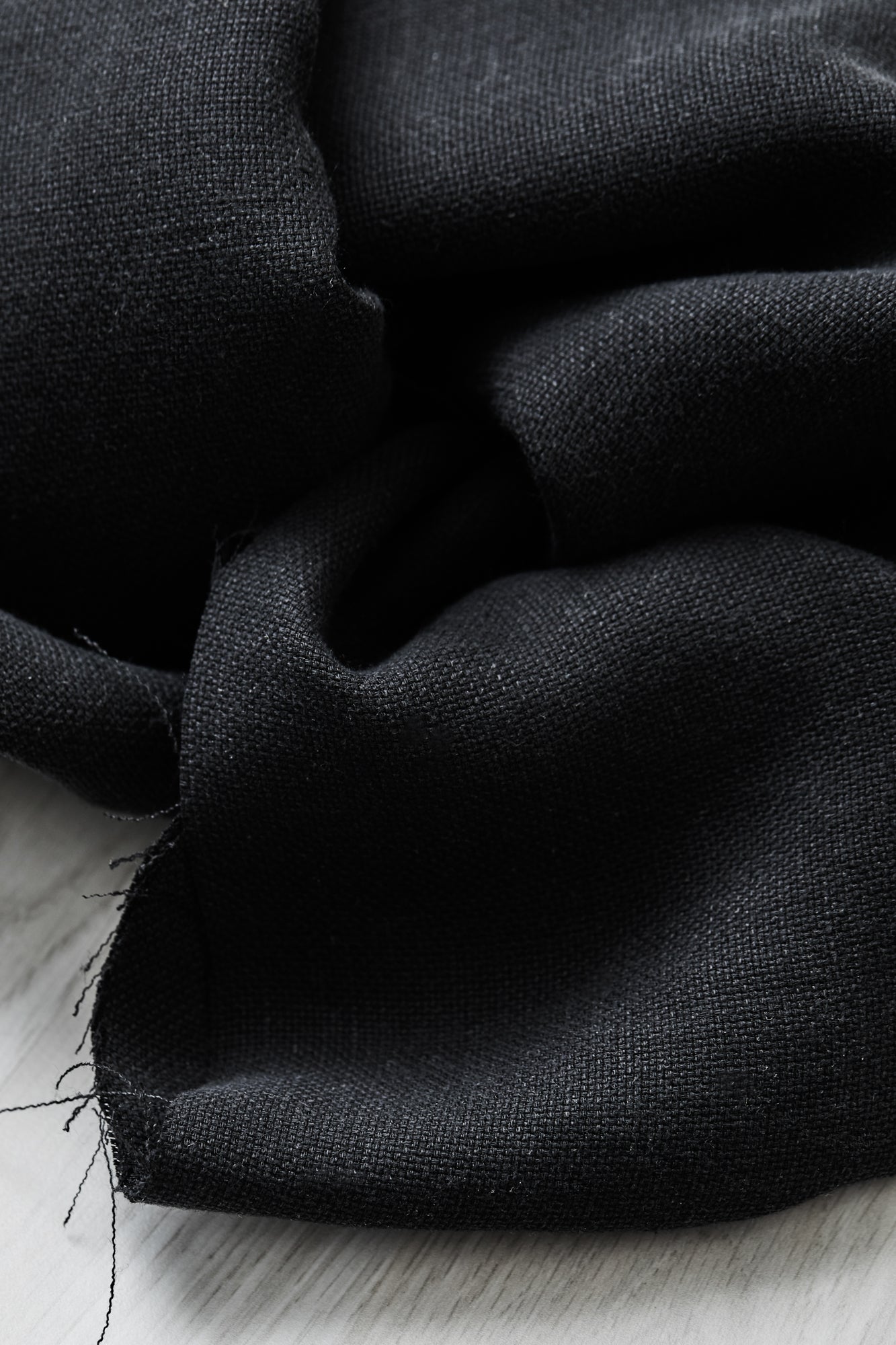 Close up of Mara linen blend tencel sewing fabric in black