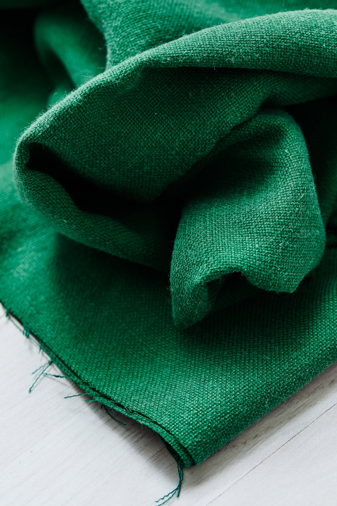 Close up of Mara linen blend tencel sewing fabric in frog green