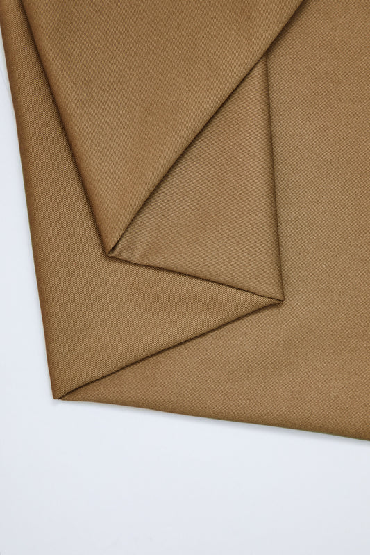 Flat lay of organic cotton twill fabric in colour camel (tan brown)