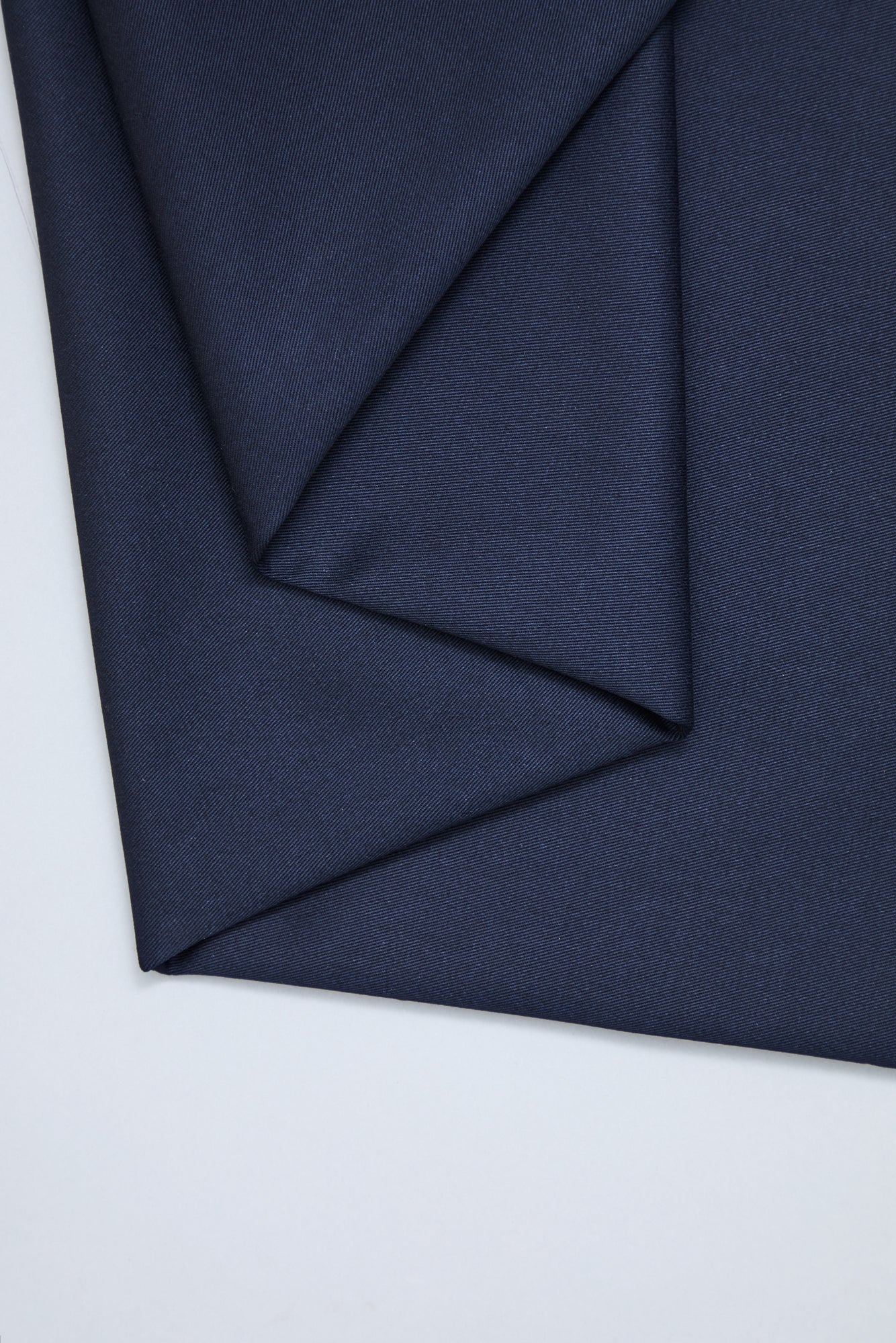 Flat lay of organic cotton twill sewing fabric in indigo night, navy