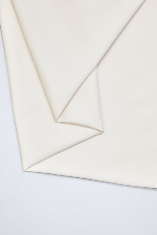 Flat lay of organic cotton twill fabric in creamy white colour