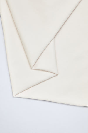 Flat lay of organic cotton twill fabric in creamy white colour