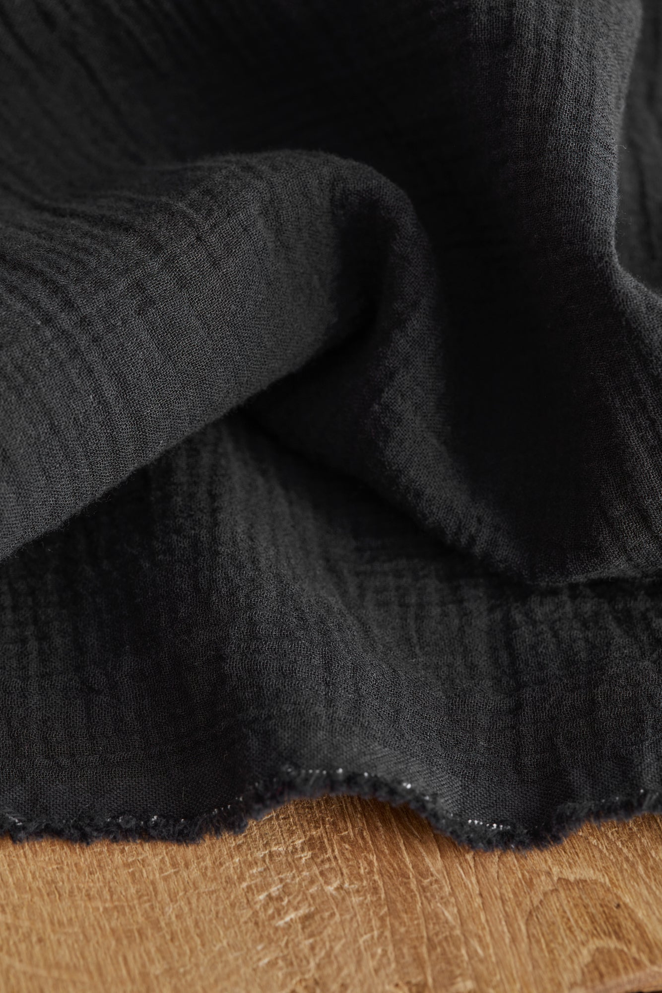 Close up of organic cotton double gauze sewing fabric in black