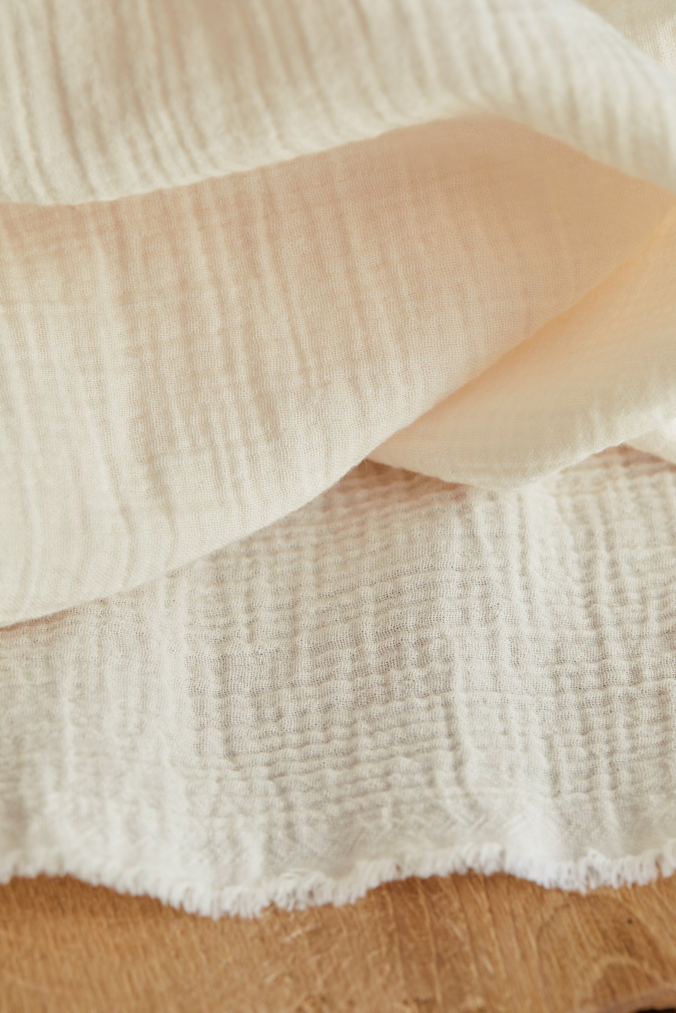 Close up of organic cotton double gauze fabric in creamy white