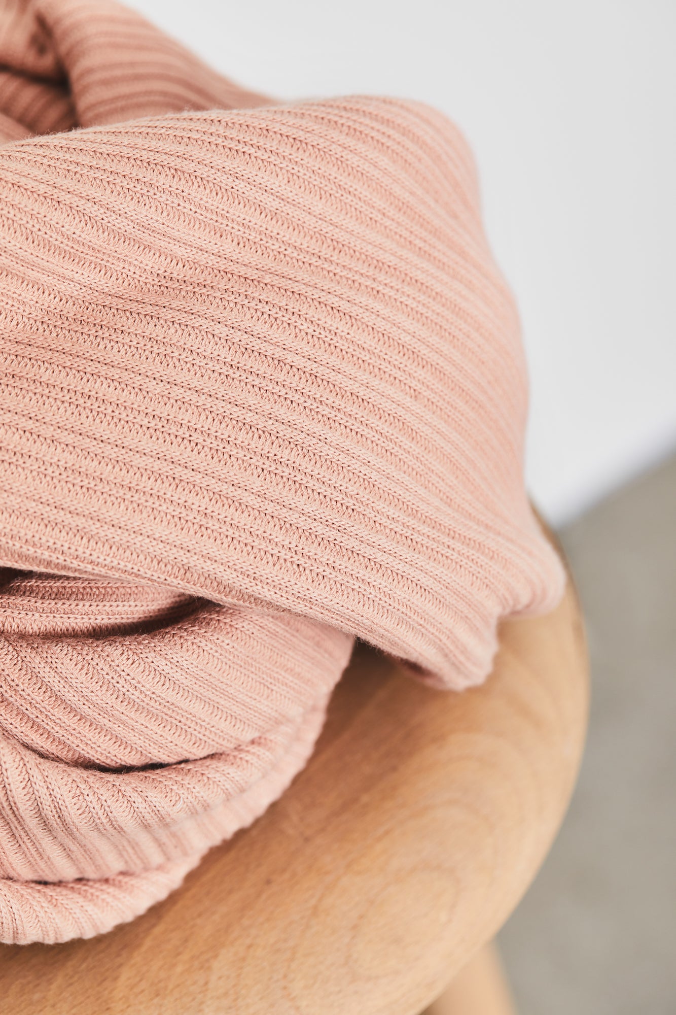 Close up of chunky organic cotton ribbed knit sewing fabric in colour rose