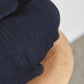 Close up of organic cotton chunky rib knitted fabric in navy
