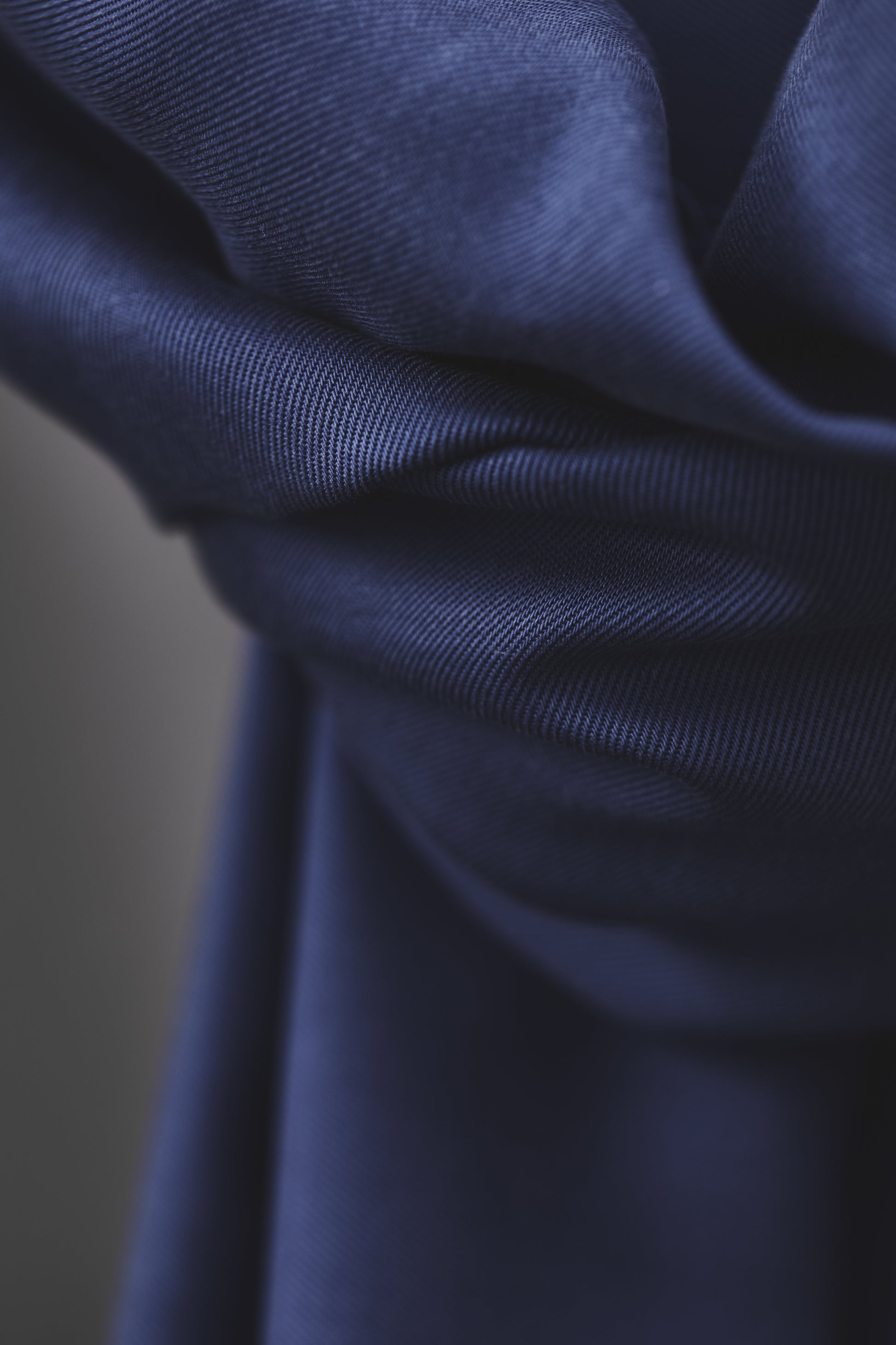 Close up of smooth drape twill tencel fabric in colour lapis