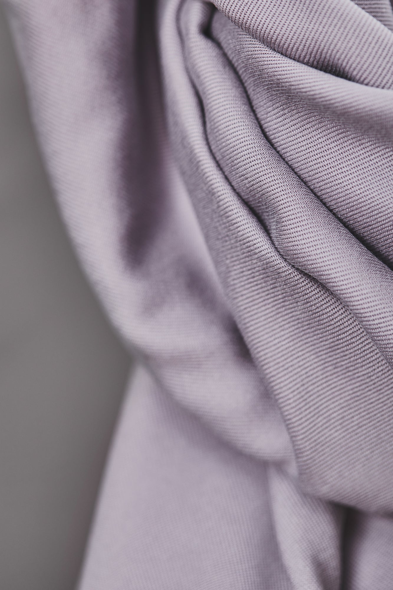 Close up of smooth drape twill tencel sewing fabric in colour purple haze (lilac)