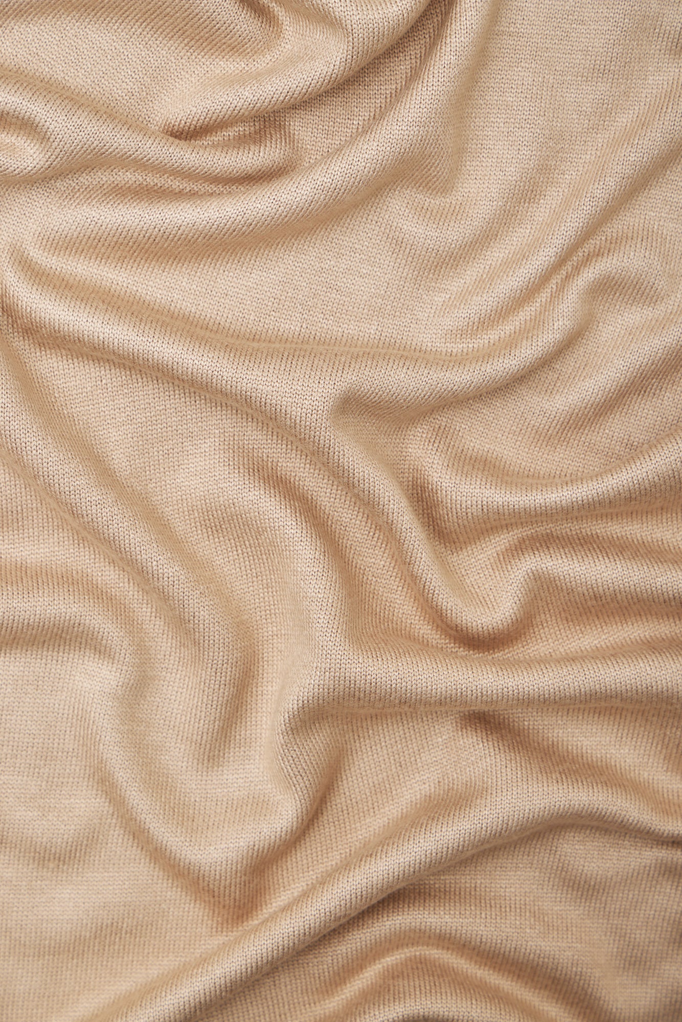 Close up of warm sand (beige) Ecovero knit sewing fabric