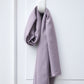 Piece of Vida voile tencel sewing fabric in colour purple haze, hanging on white hook