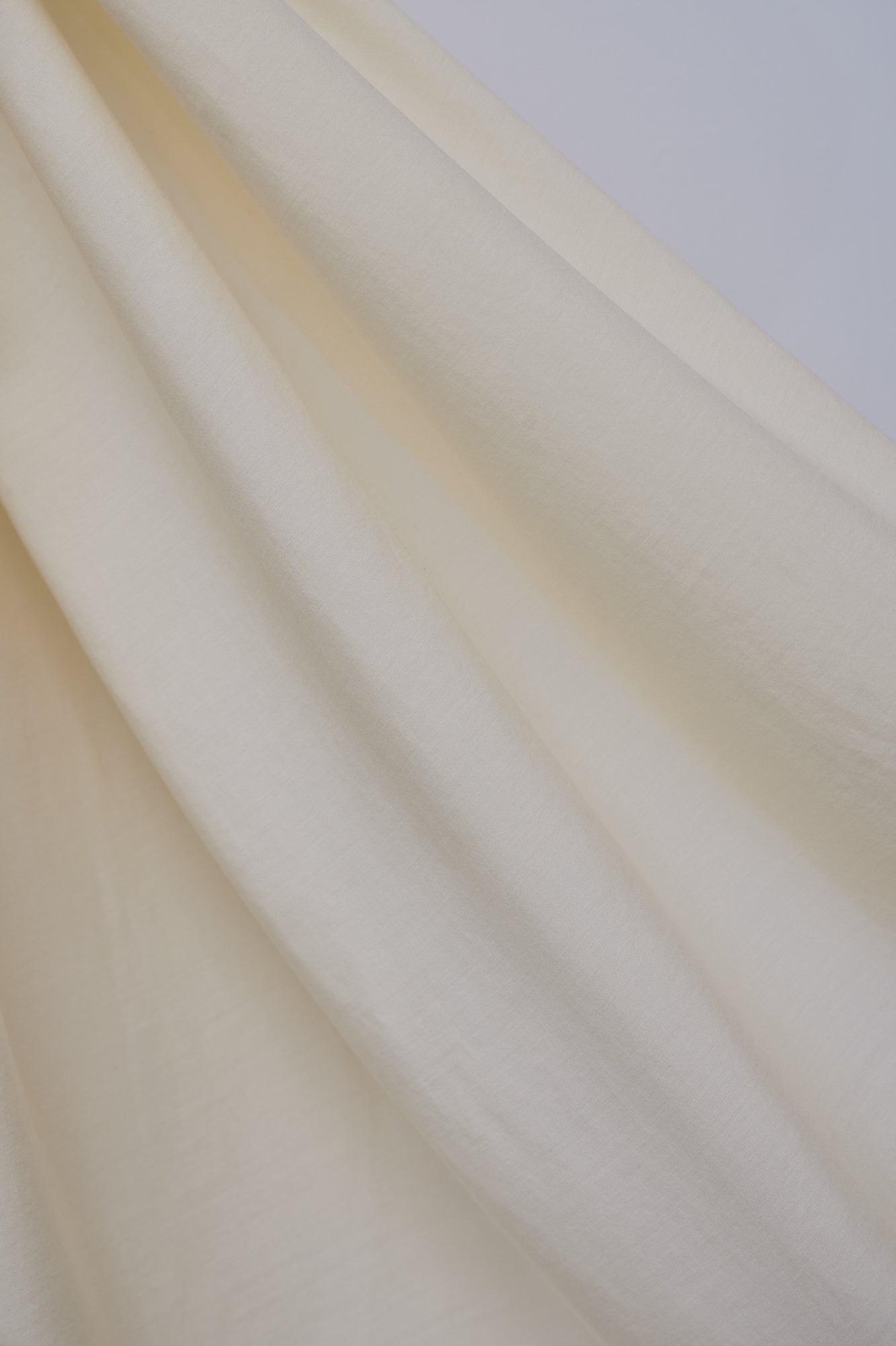 Close up of Vida voile tencel sewing fabric in colour shell (cream)
