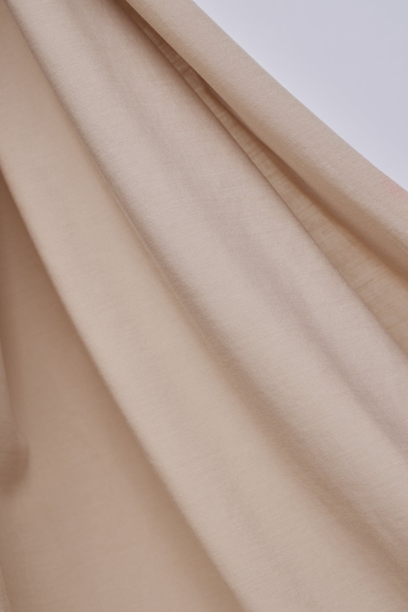 Close up of Vida voile tencel sewing fabric in colour warm sand, beige